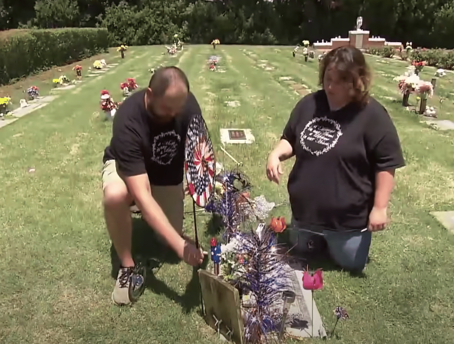 A couple sit at the gravesite of their baby boy. | Source: youtube.com/Inside Edition
