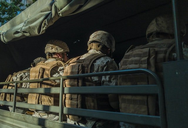 Soldiers in the back of a truck | Source: Unsplash