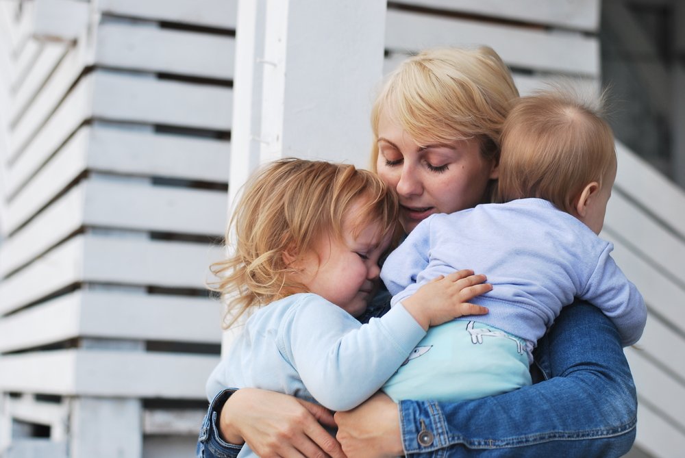 A sad woman with two kids. | Photo: Shutterstock