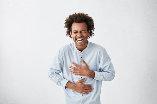 A young man laughing out loud. | Source: Shutterstock.
