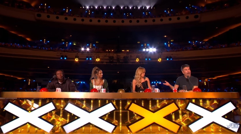 Simon Cowell gestures towards the panel during a discussion following the high-energy performance. | Source: YouTube/Britain's Got Talent