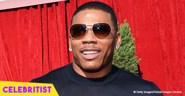Nelly's longtime girlfriend flaunts enviable curves in latex black midi dress in recent photos