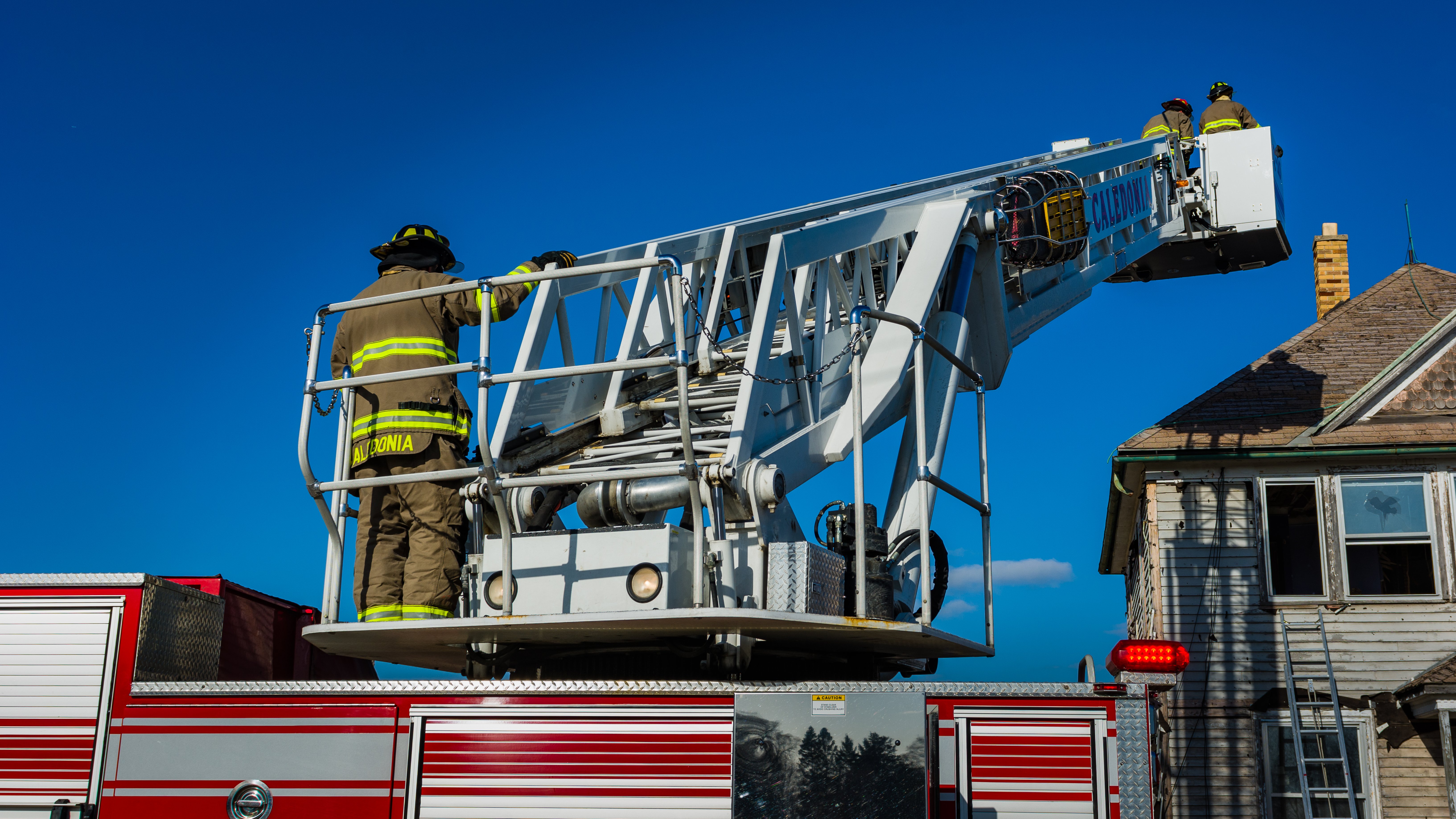 Firemen doing a chimney rescue | Source: Shutterstock