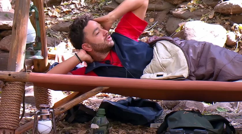 Adam Thomas reclines on his camp bed, appearing to regroup as emotions settle following the heated back-and-forth. | Source: YouTube/I'm A Celebrity... Get Me Out Of Here!