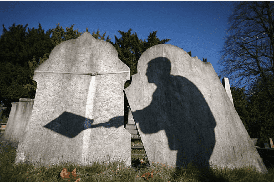 Shadow of tombstone worker reclaiming only graves on March 2, 2009, in London, England | Source: Getty Images