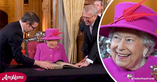 Queen beams in magenta coat to sign a special 'Golden Book' on her last outing before Christmas