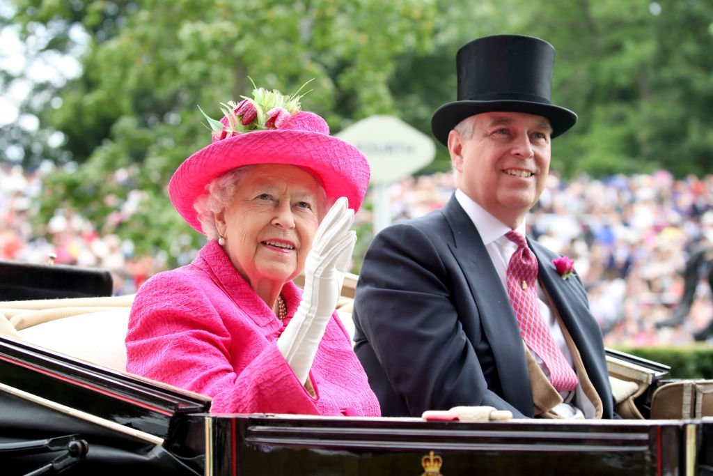 Queen Elizabeth and Prince Andrew wave to crowds from a carriage as they attend the Royal Ascot on June 22, 2017, in Ascot, England | Source: Chris Jackson/Getty Images