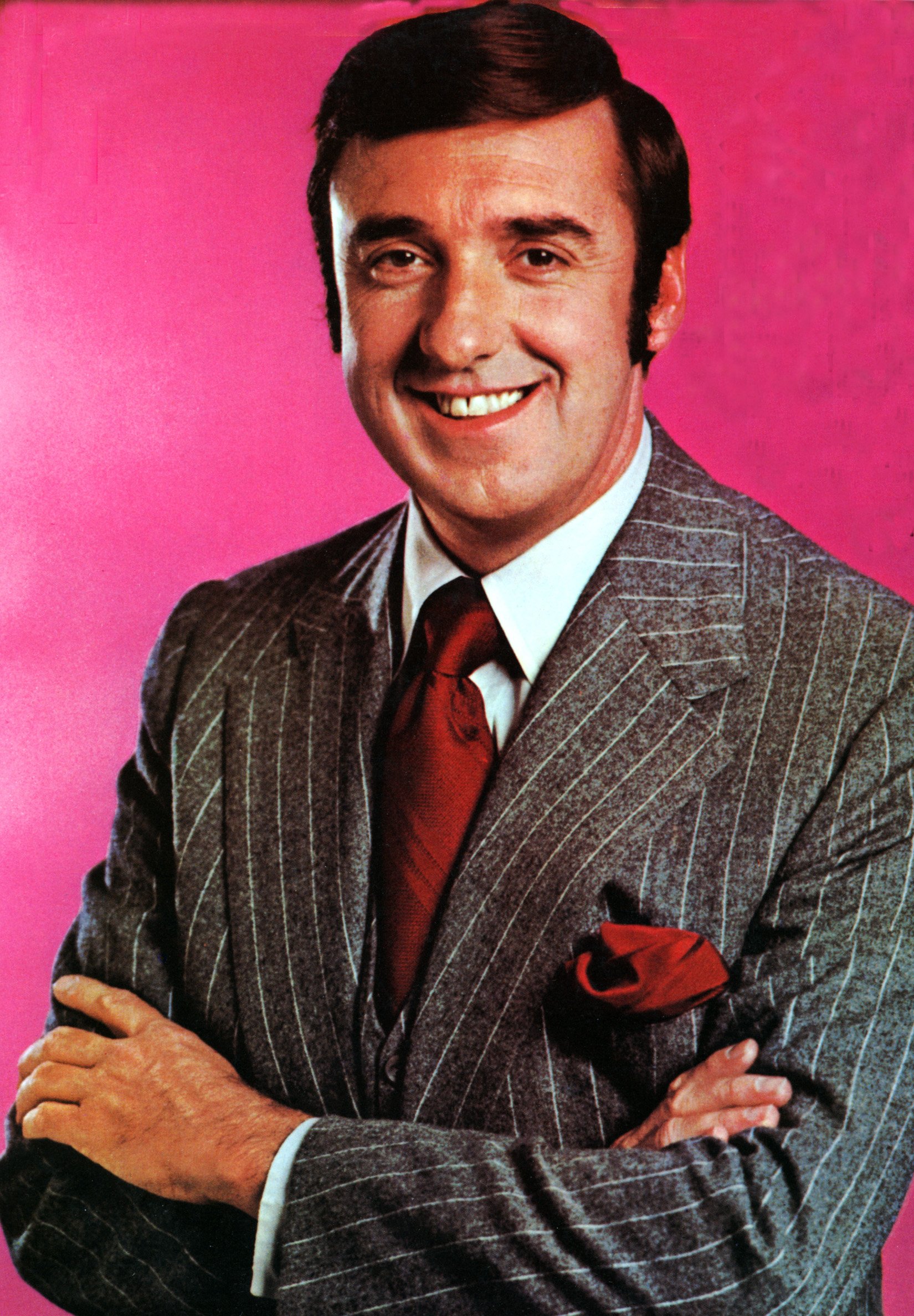 A headshot portrait of television icon Jim Nabors posing while folding his arms. | Source: Getty Images