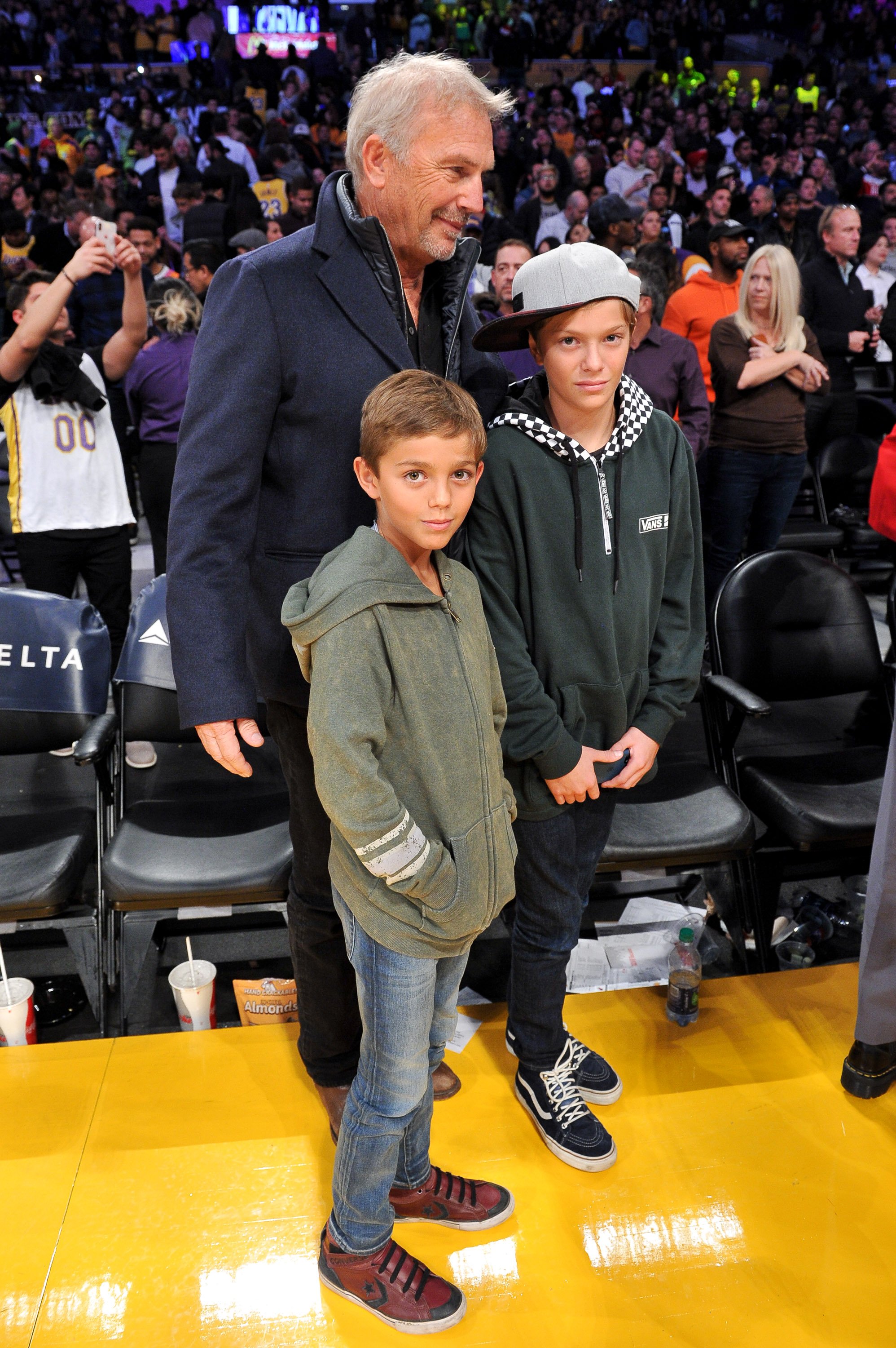 Cayden Costner, his dad and brother at an NBA game in California on December 10, 2018 | Source: Getty Images 
