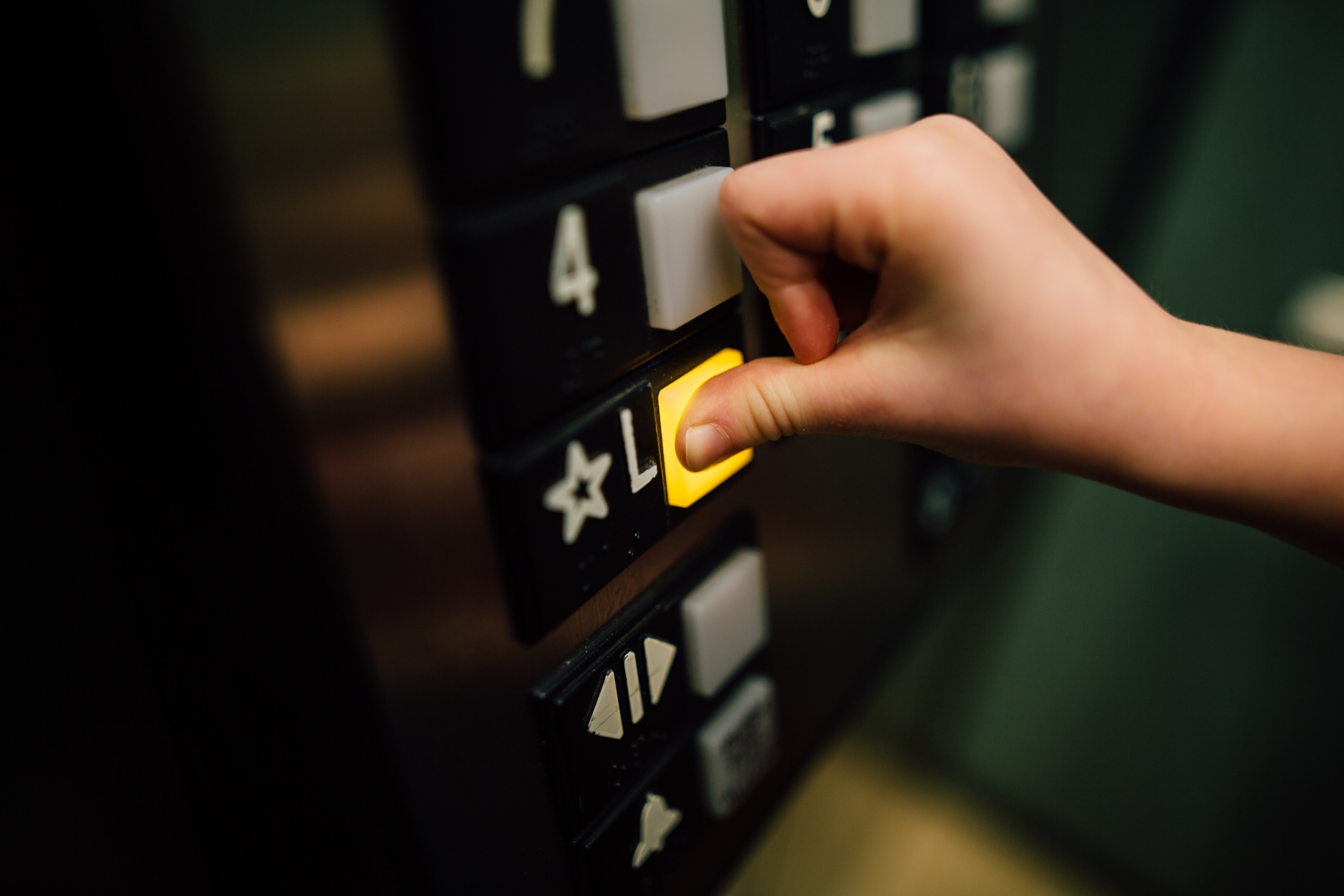 A hand pressing buttons inside an elevator | Source: Pexels
