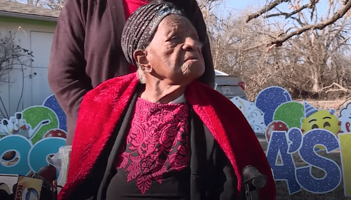 A 103-year-old Oklahoma woman who beat COVID-19 looks on as loved ones surprise her with a birthday parade on January 30, 2021. 