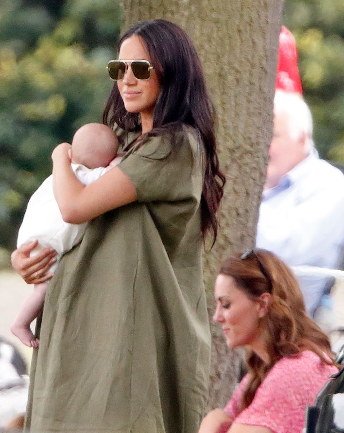 Meghan Markle holding Archie Harrison Mountbatten-Windsor and Catherine Middleton attend the King Power Royal Charity Polo Match, in which Prince William, Duke of Cambridge and Prince Harry, Duke of Sussex were competing for the Khun Vichai Srivaddhanaprabha Memorial Polo Trophy at Billingbear Polo Club on July 10, 2019 in Wokingham, England. | Source: Getty Images