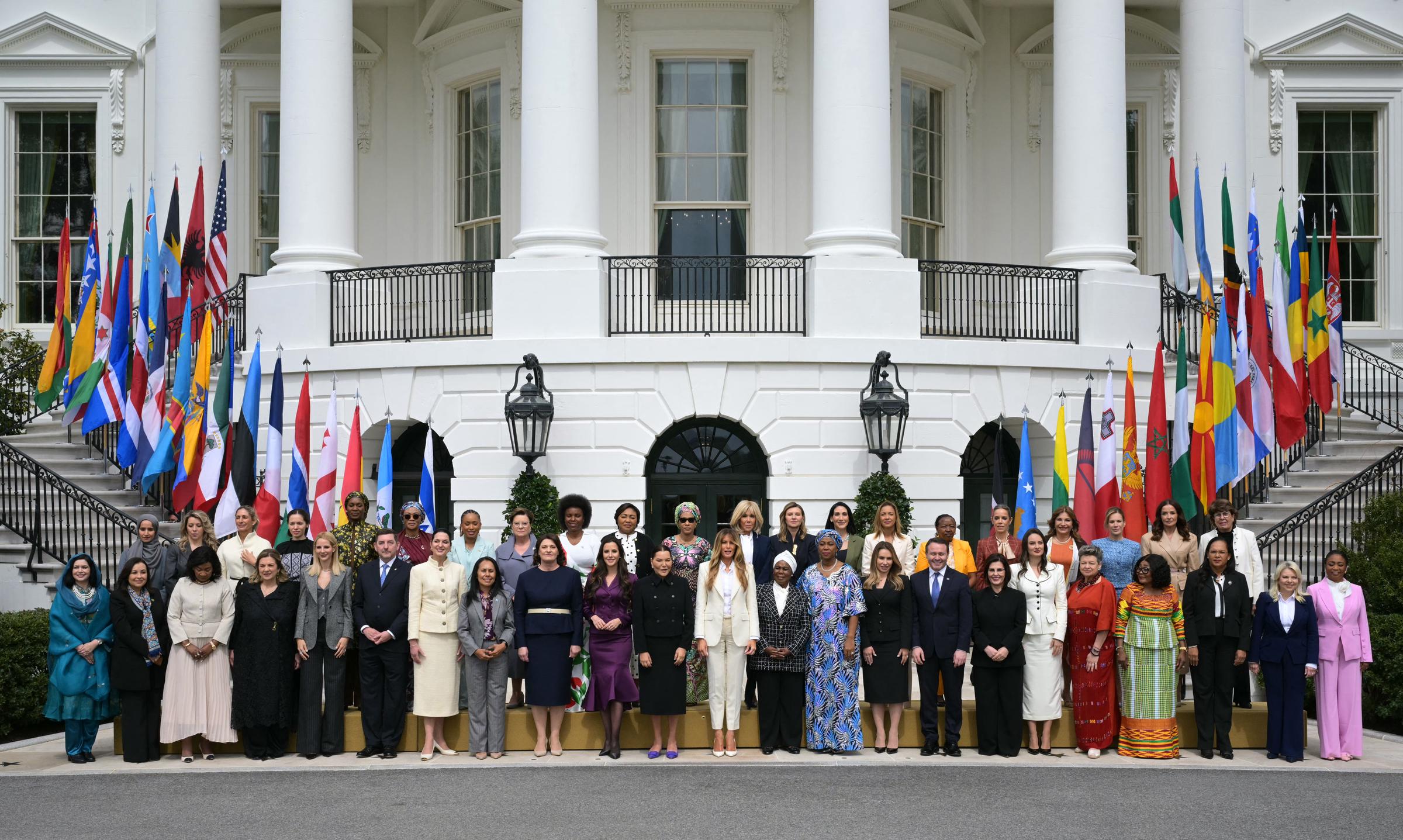 Melania Trump poses with attendees during the "Fostering the Future Together" Global Coalition inaugural meeting at the White House in Washington, D.C. on March 25, 2026. | Source: Getty Images