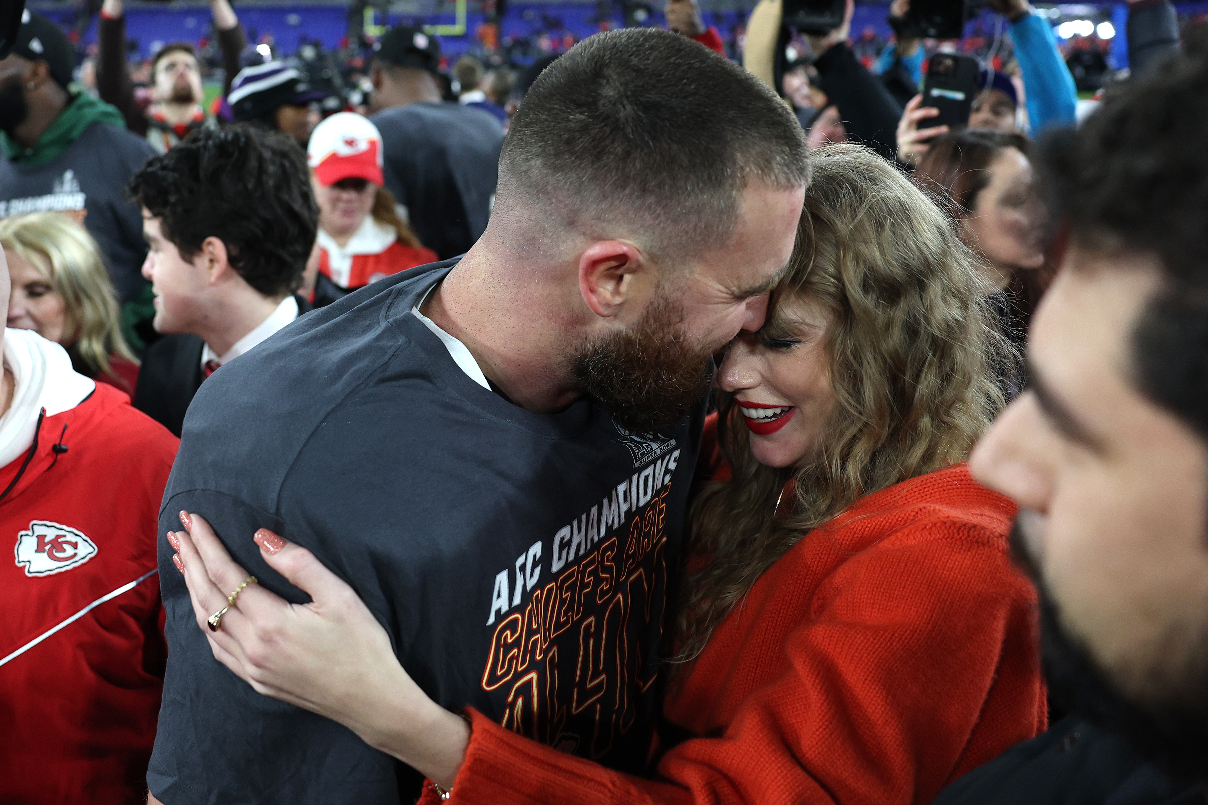 Travis Kelce #87 of the Kansas City Chiefs shares an emotional embrace with Taylor Swift on the field after the team's 17-10 victory over the Baltimore Ravens in the AFC Championship Game at M&T Bank Stadium on January 28, 2024, in Maryland.