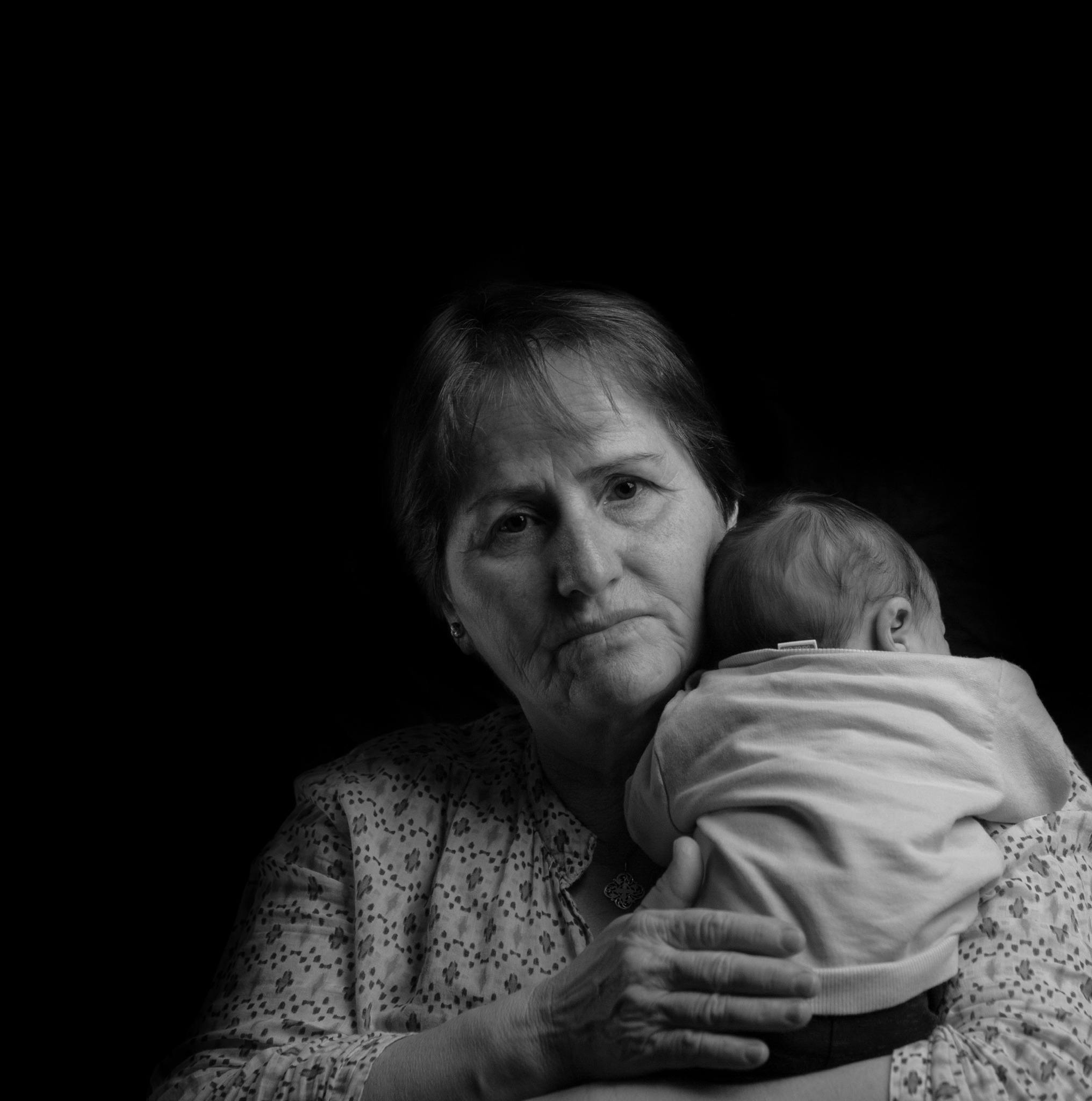 An upset senior woman holding a baby | Source: Pexels