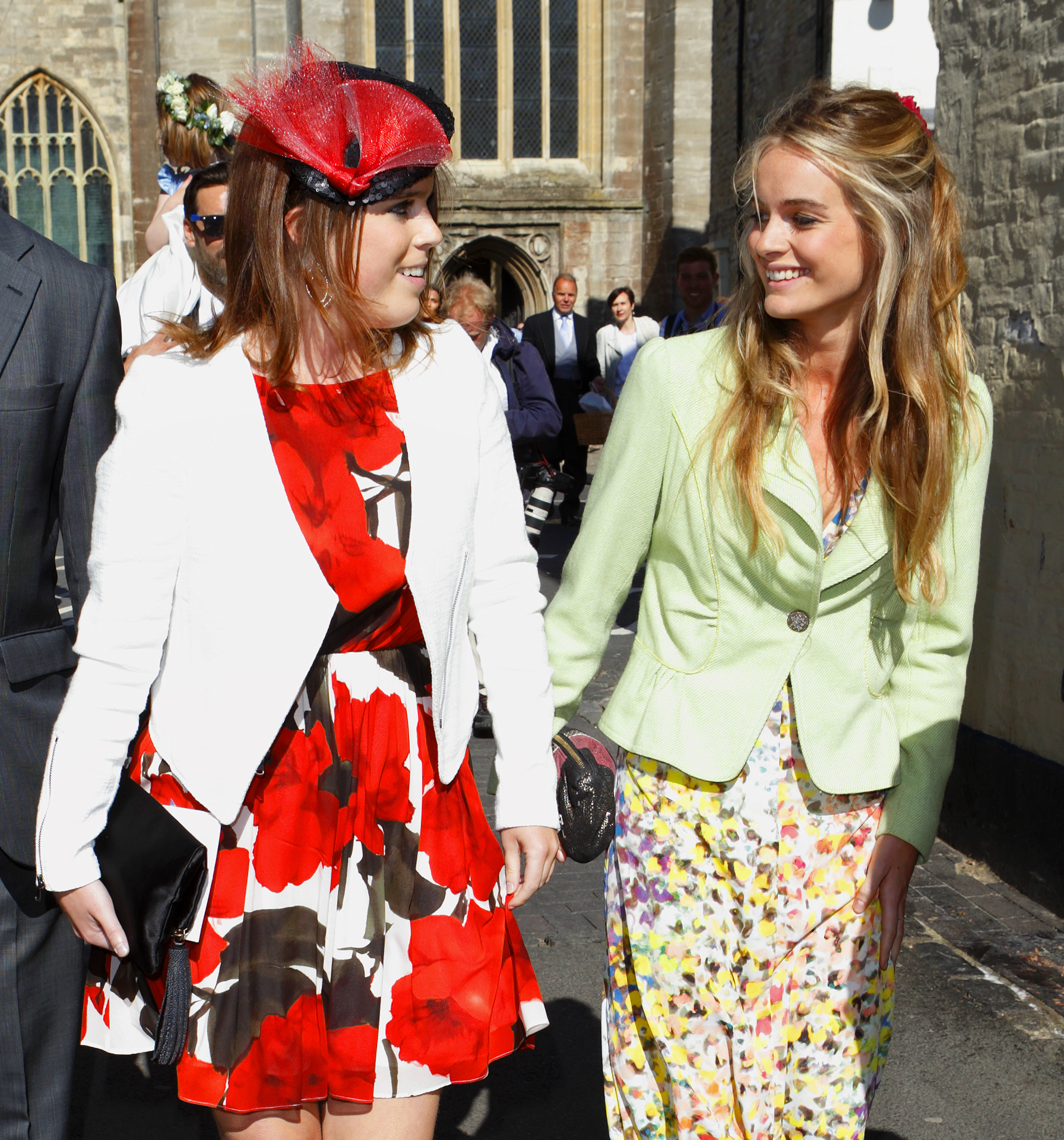 Princess Eugenie and Cressida Bonas attend the wedding of Lady Natasha Rufus Isaacs and Rupert Finch at the church of St John the Baptist on June 8, 2013 in Cirencester, England. | Source: Getty Images
