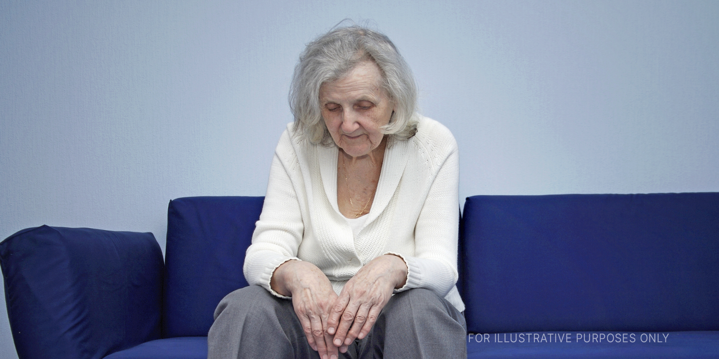 Tired elderly woman sitting on couch | Source: Getty Images