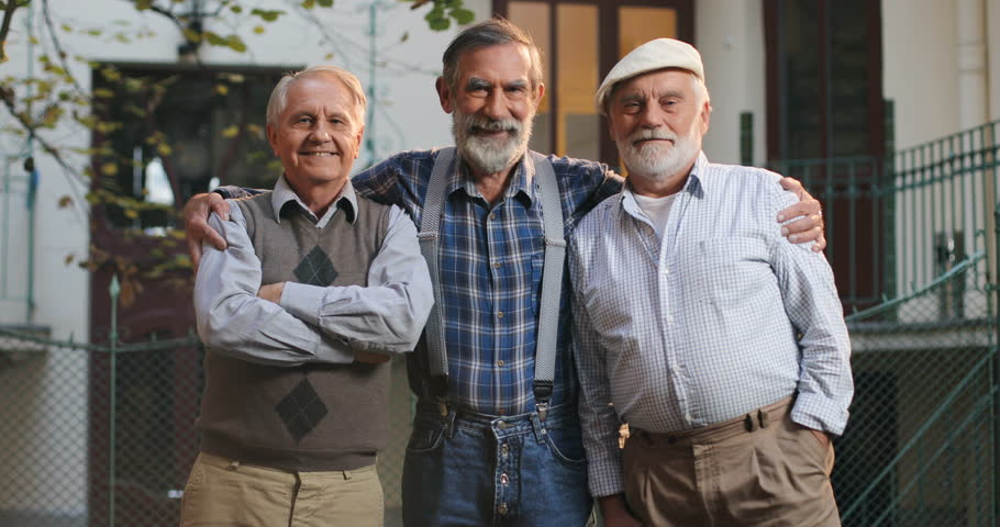 Three old men hugging each other | Photo: Shutterstock
