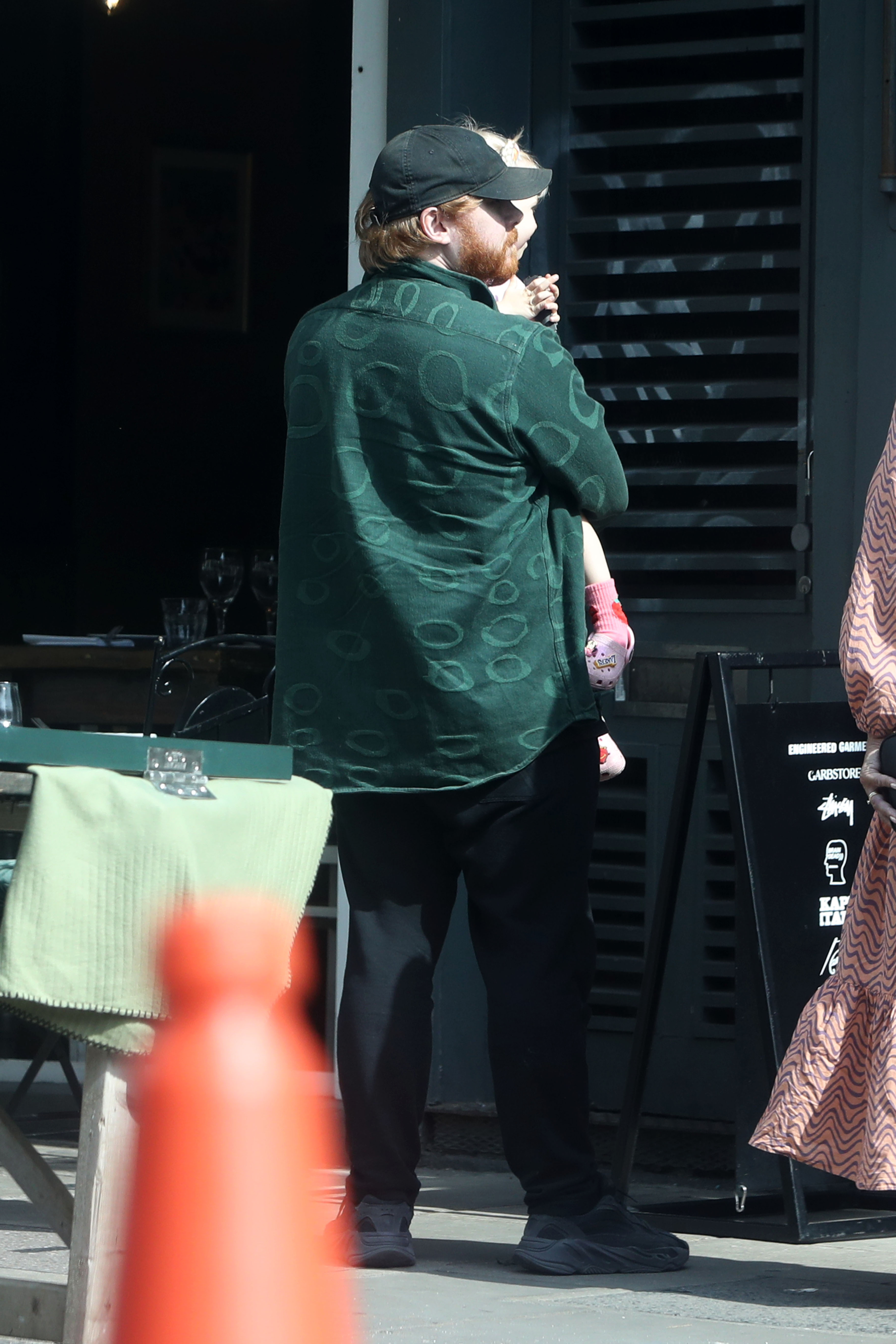 Rupert Grint holding his daughter Wednesday G.Grint while out in London, England on September 8, 2023 | Source: Getty Images