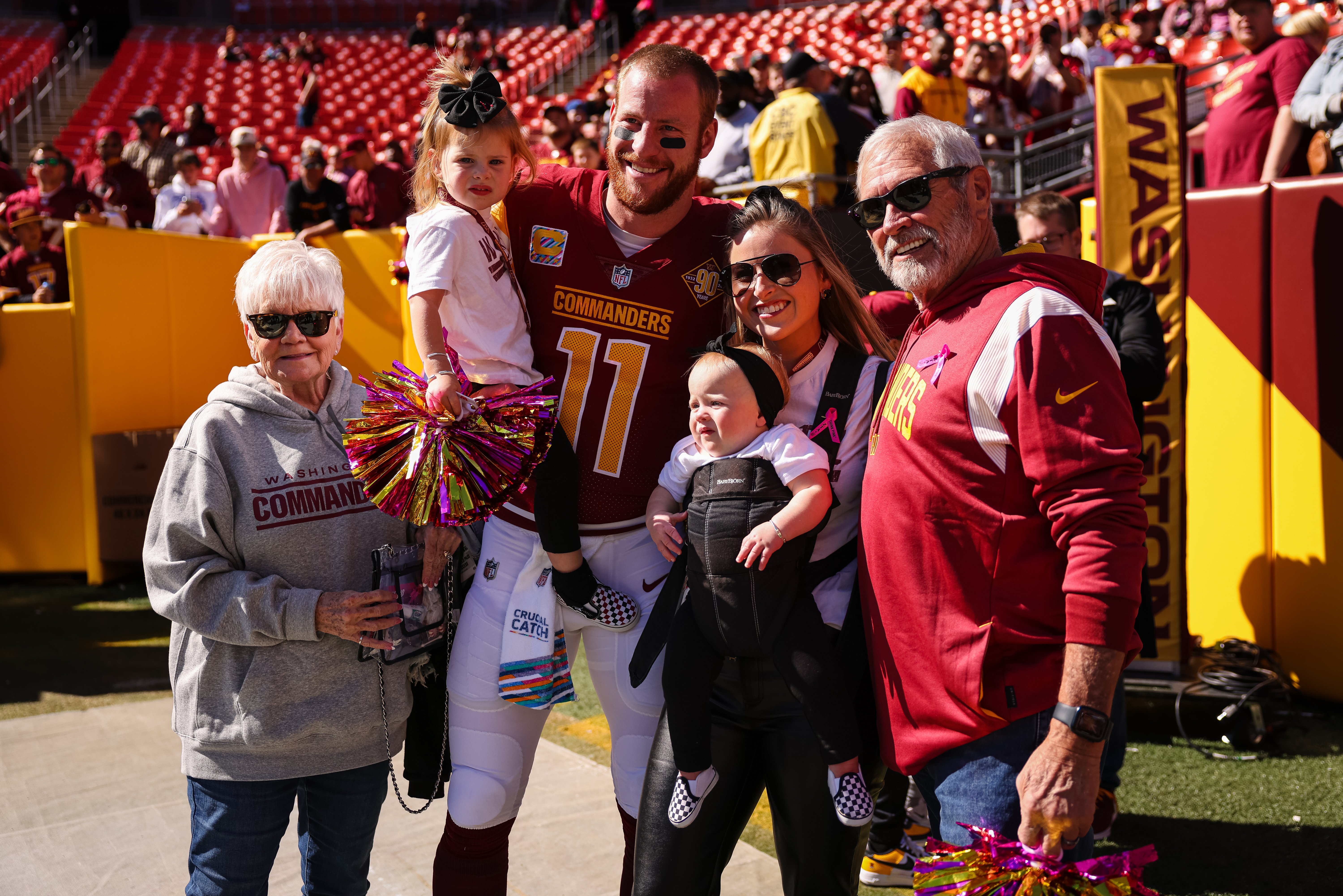 Carson Wentz poses with his wife, Madison Oberg, and their children and family before the game against the Tennessee Titans at FedExField on October 9, 2022 ,in Landover | Source: Getty Images