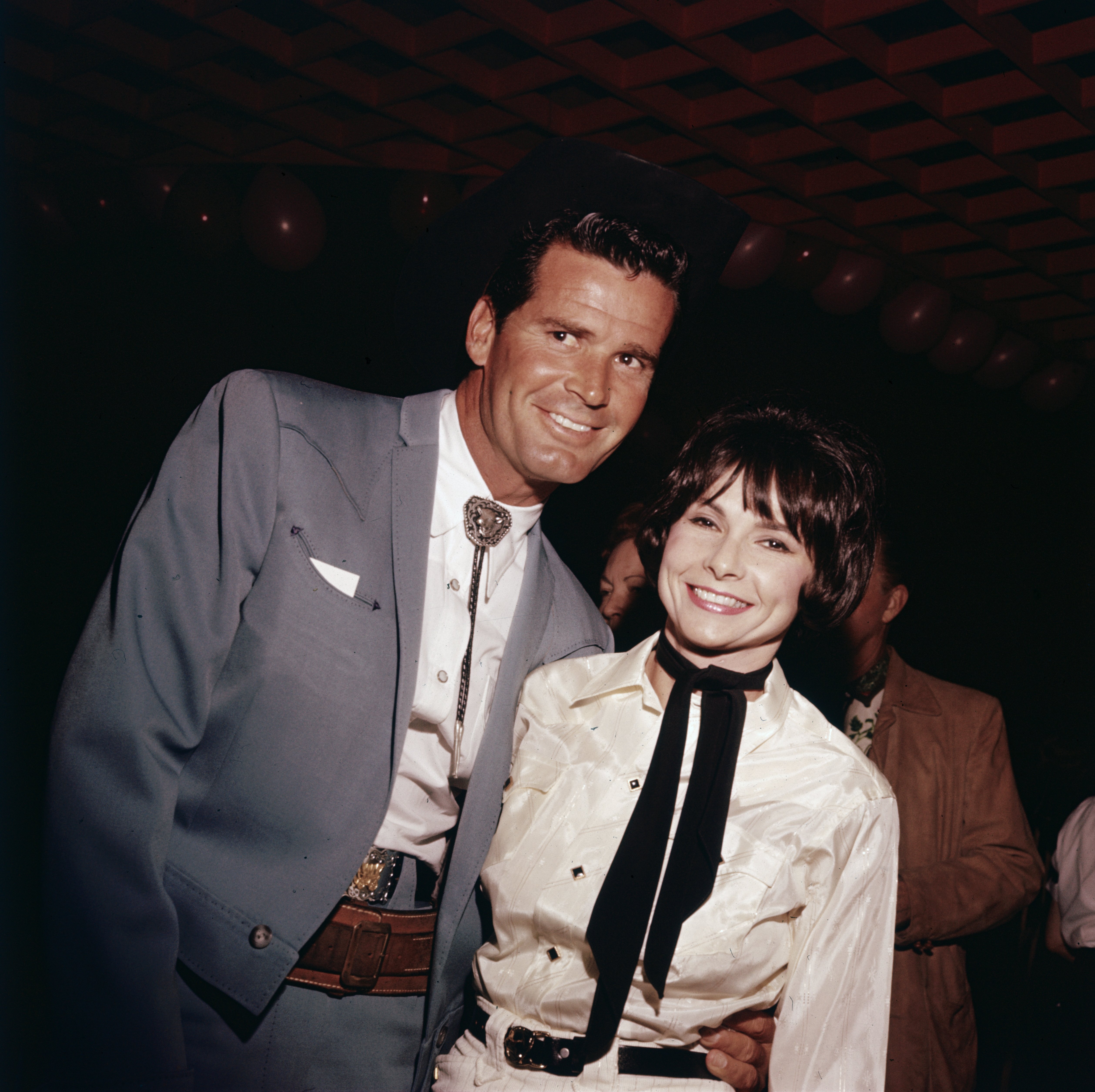 James Garner smiles with his wife, Lois Clarke, as they wear Western gear at a party in the 1960s. | Source: Getty Images