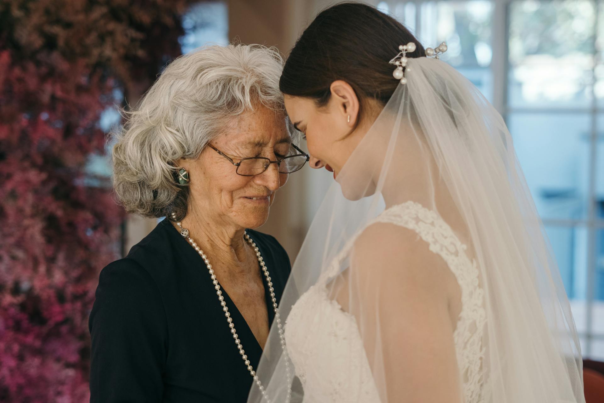 A young woman in a bridal dress sharing an emotional moment with her mother | Source: Pexels