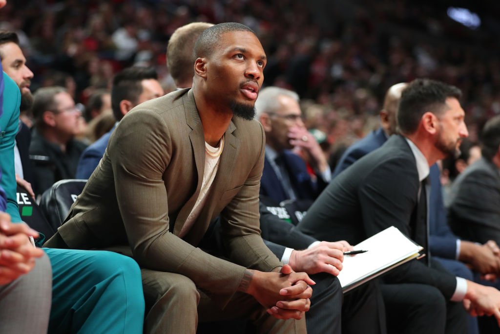 Damian Lillard #0 of the Portland Trail Blazers looks on from the bench in the fourth quarter against the Detroit Pistons during their game at Moda Center on February 23, 2020 in Portland, Oregon | Photo: GettyImages