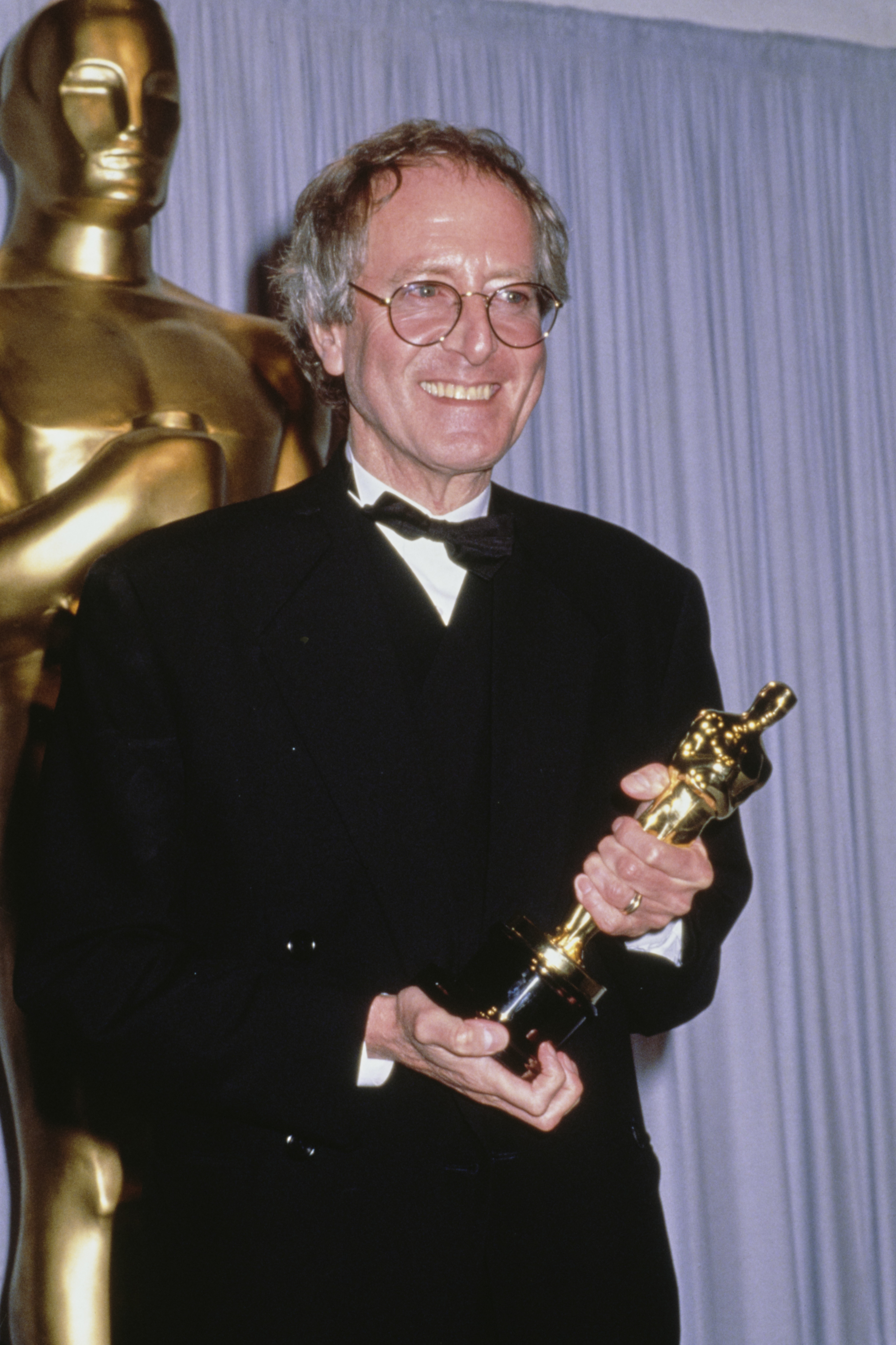 John Barry holds his Best Original Score award for "Dances with Wolves" at the 63rd Annual Academy Awards, at the Shrine Auditorium on March 25, 1991, in Los Angeles, California. | Source: Getty Images