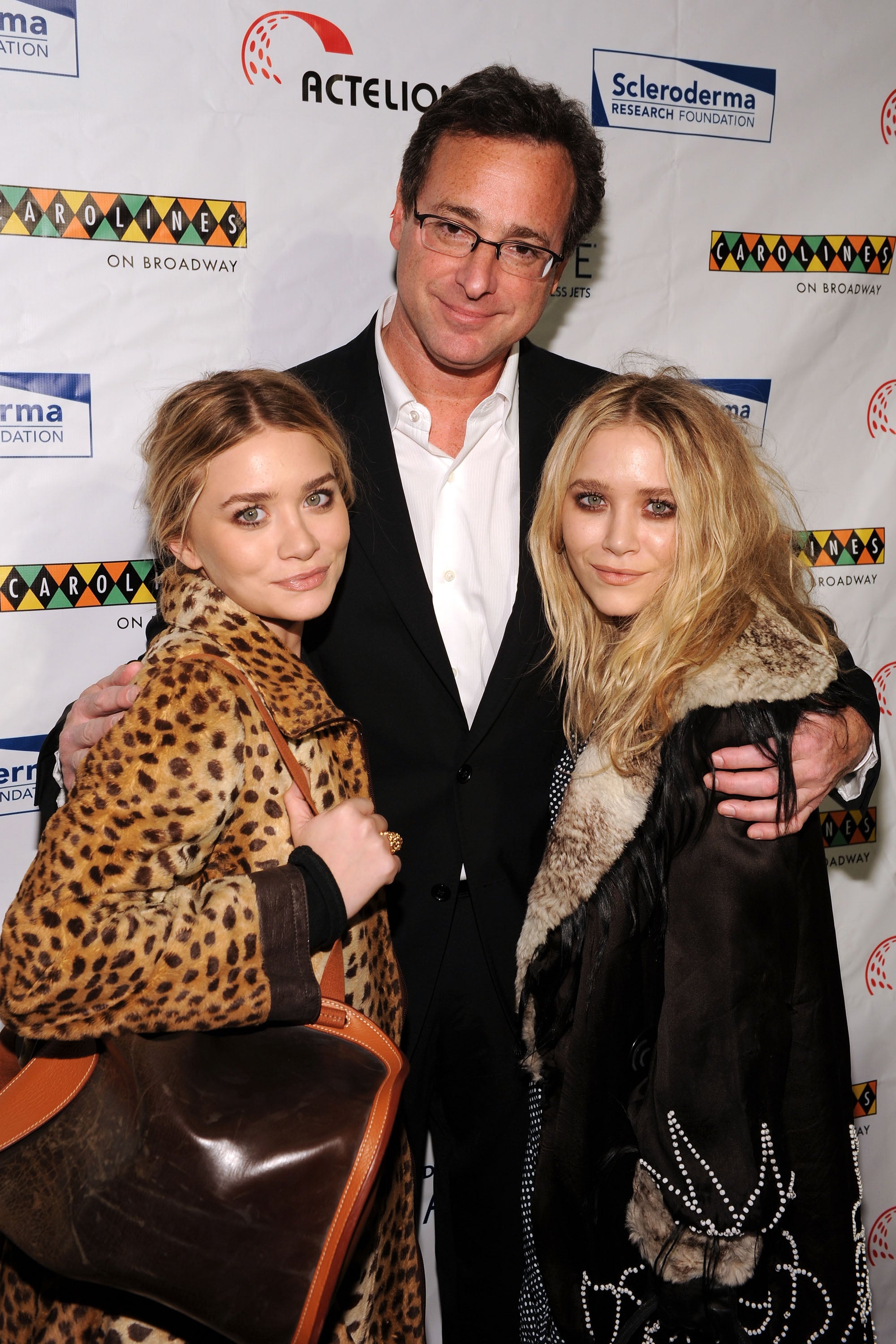 Actors Mary-Kate Olsen, Bob Saget and Ashley Olsen attend "Cool Comedy Hot Cuisine 2009" hosted by the Scleroderma Research Foundation at Carolines On Broadway on November 9, 2009 in New York City | Source: Getty Images