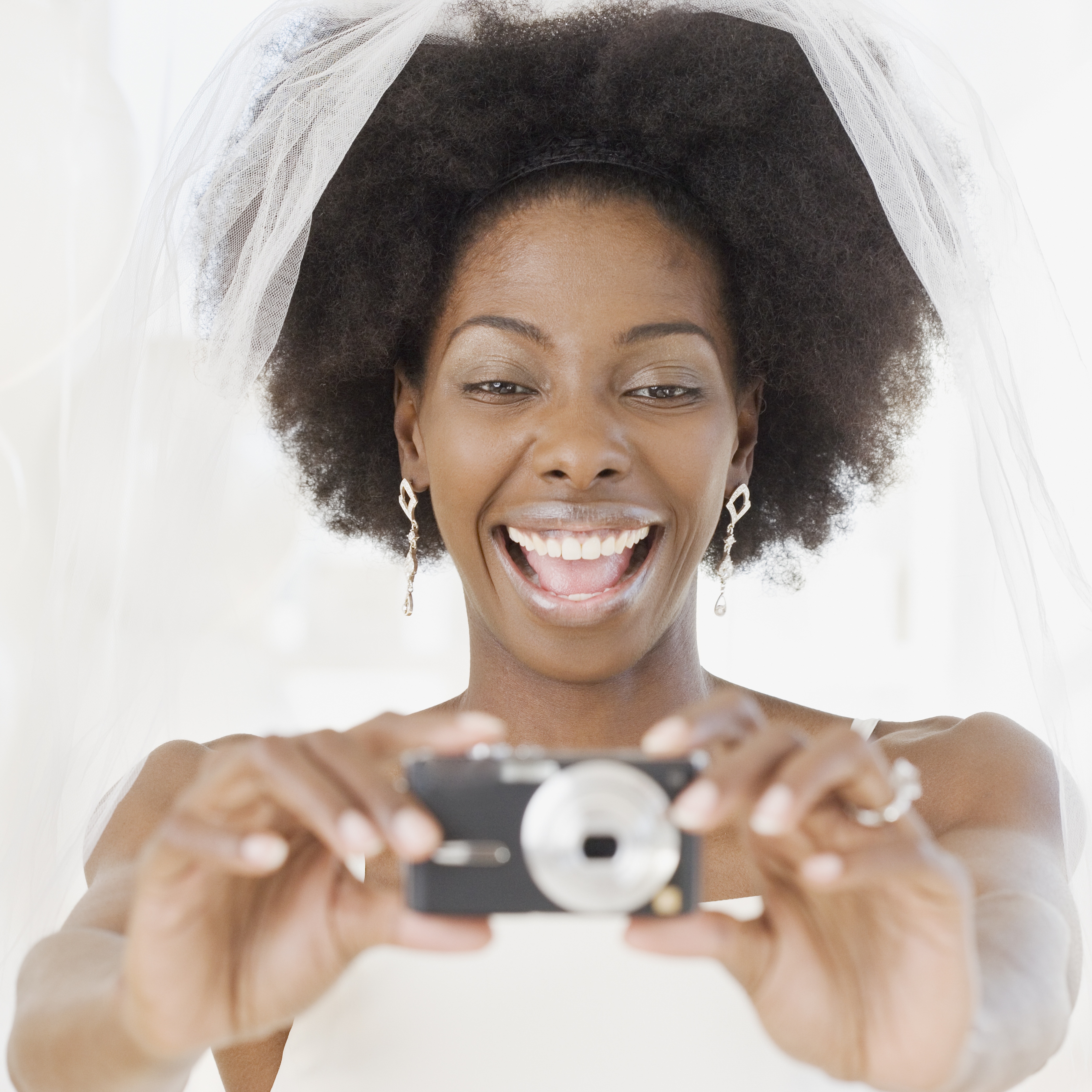 African bride taking photograph | Source: Getty Images