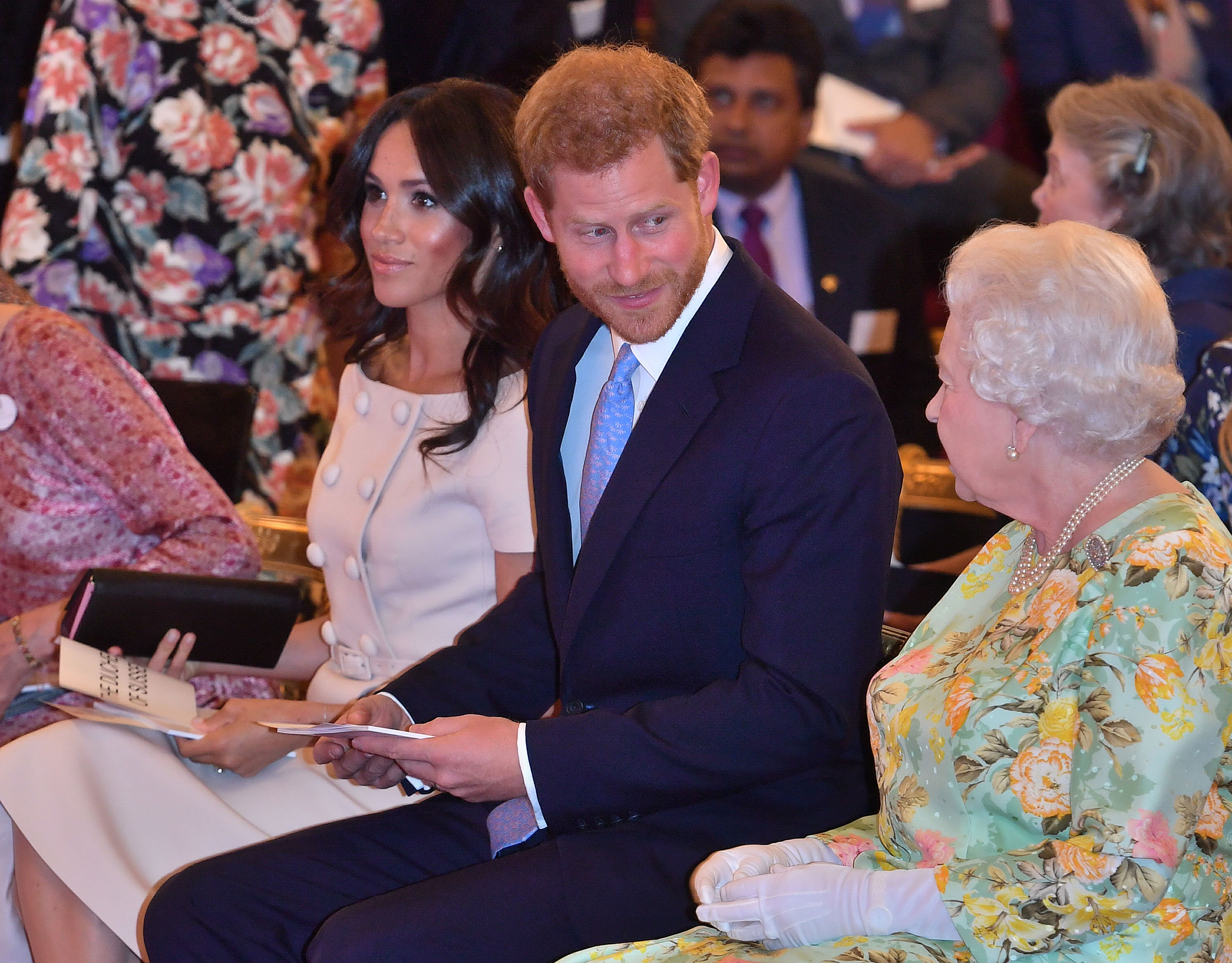 Duchess Meghan, Prince Harry, and Queen Elizabeth II at the Queen's Young Leaders Award Ceremony at Buckingham Palace on June 26, 2018, in London, England. | Source: Getty Images