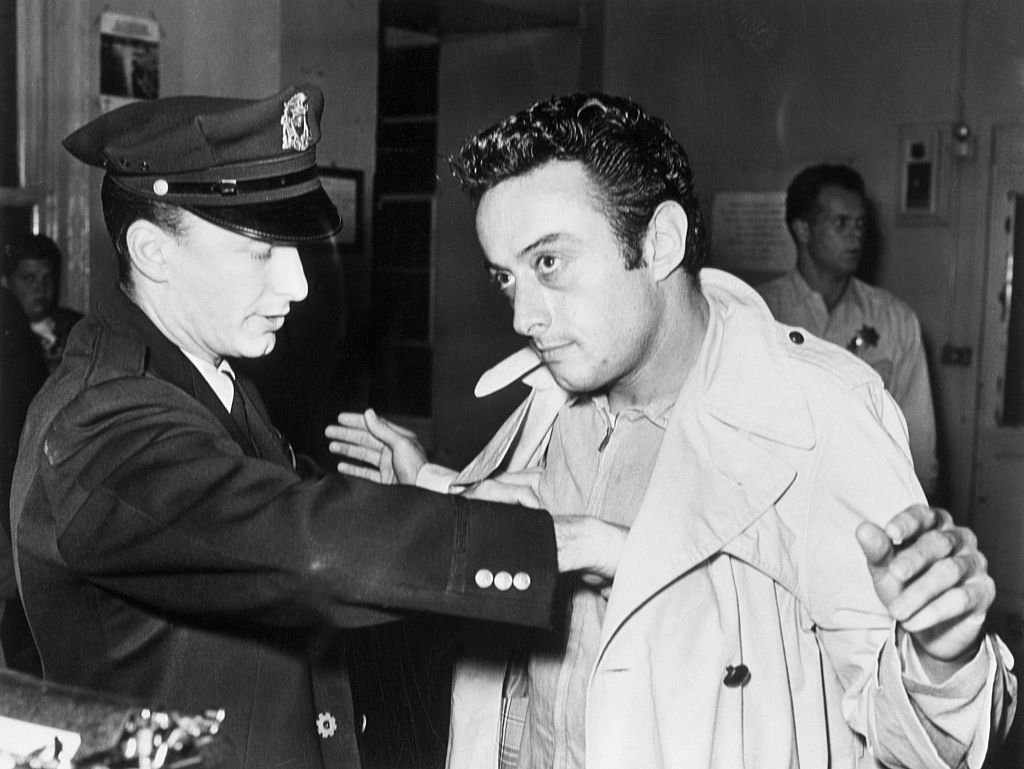 A policeman searches comedian Lenny Bruce after Bruce's arrest for allegedly using obscene language during his act in a North Beach nightclub, the Jazz Workshop circa 1961 | Photo: Getty Images