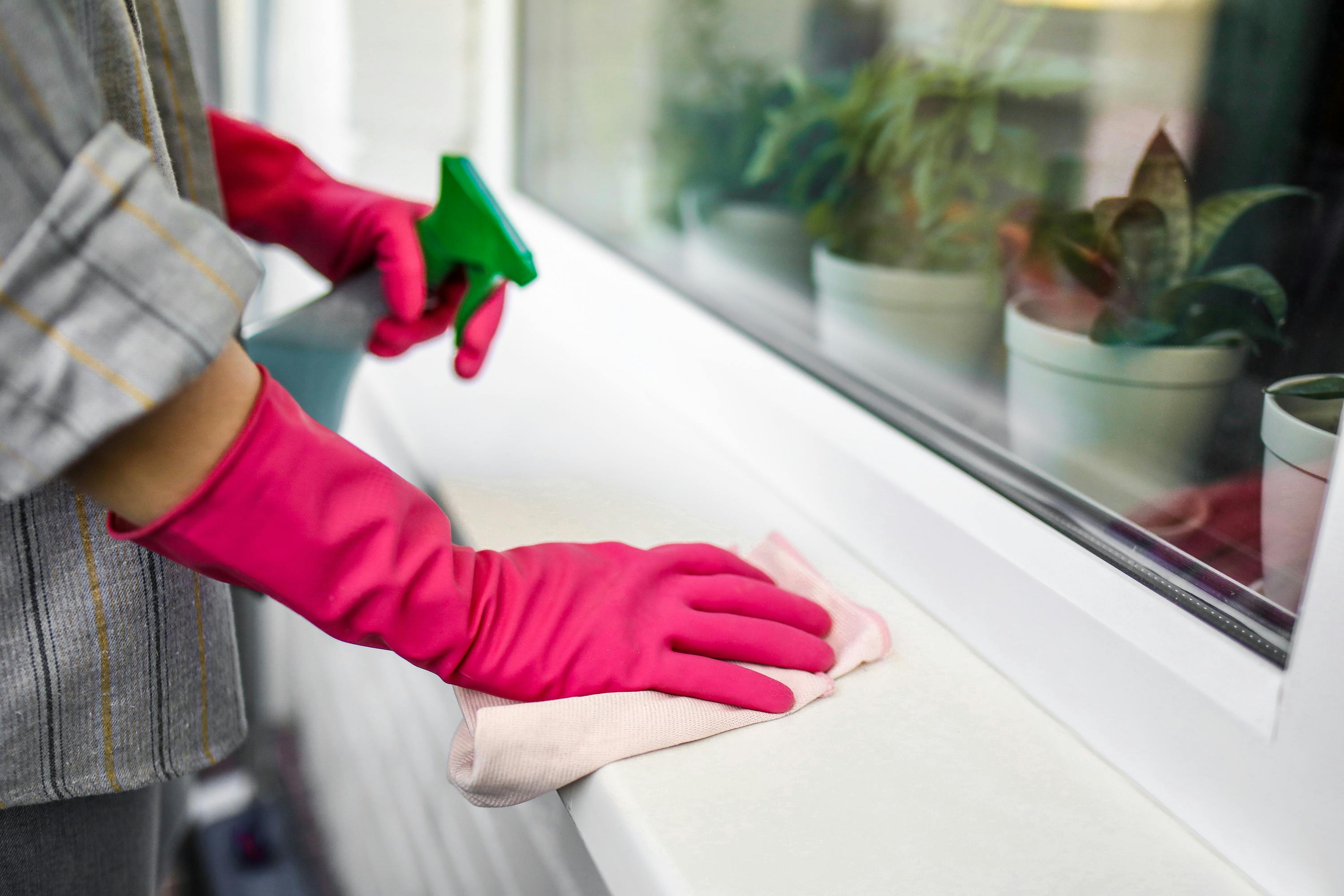 A person wiping down their window area | Source: Pexels