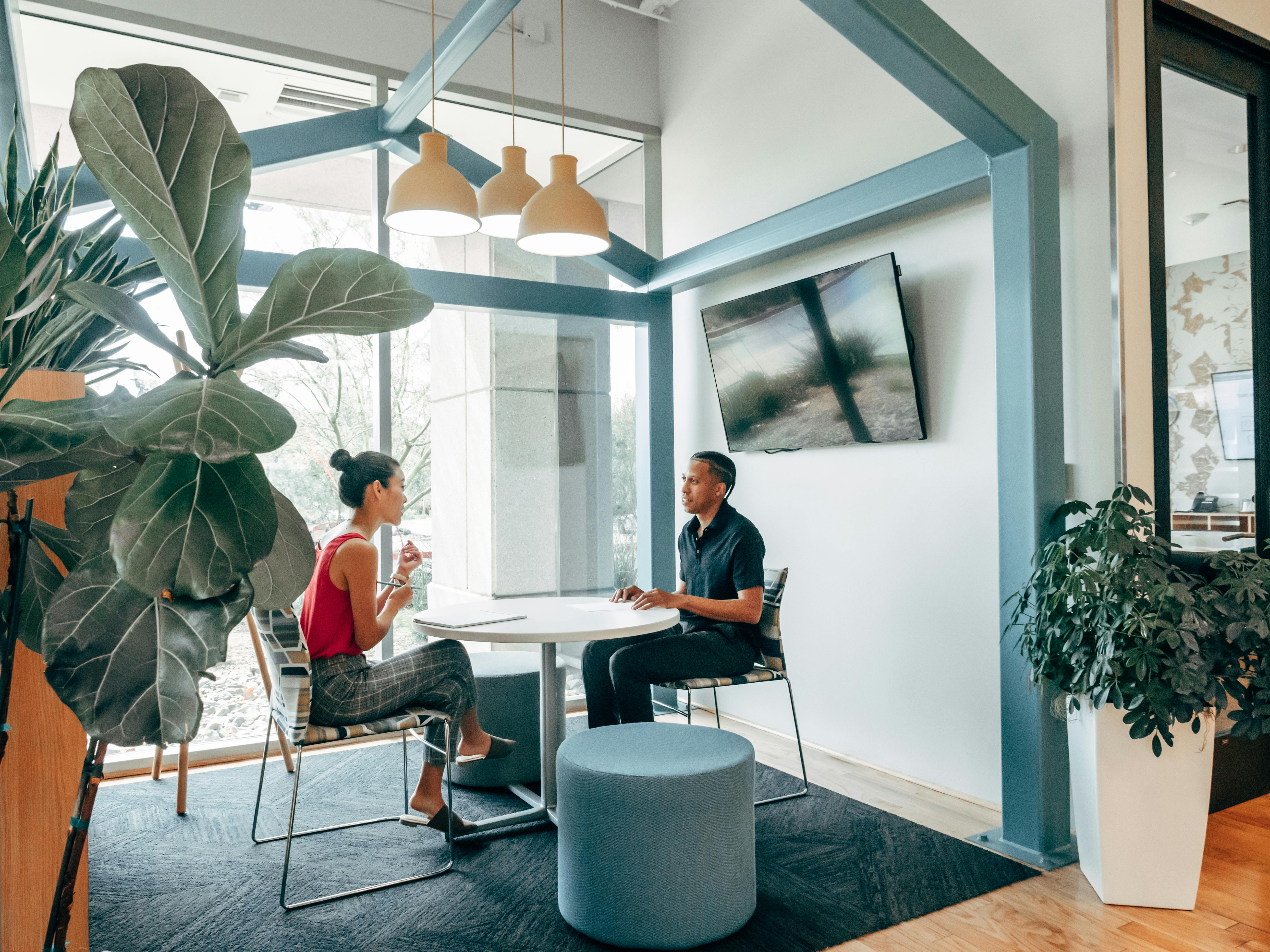 A man and woman sitting across the table from each other talking | Source: Pexels