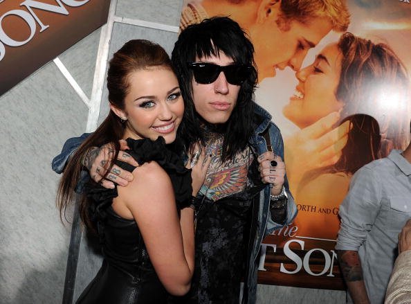 Miley Cyrus (L) and musician Trace Cyrus arrive at the premiere of Touchstone Picture's "The Last Song" held at ArcLight Hollywood on March 25, 2010, in Los Angeles, California. | Source: Getty Images.