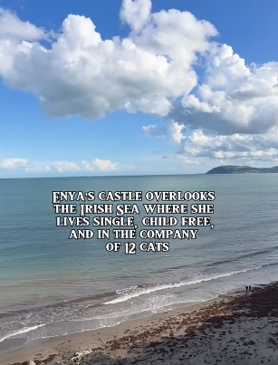Beyond the castle walls, the Irish Sea stretches towards the horizon, its gentle waves meeting a quiet shoreline under towering clouds. The sweeping coastal vista reflects the sense of space and solitude Enya has long associated with home, a landscape that frames her retreat from the spotlight. | Source: YouTube/@beforethecoffin