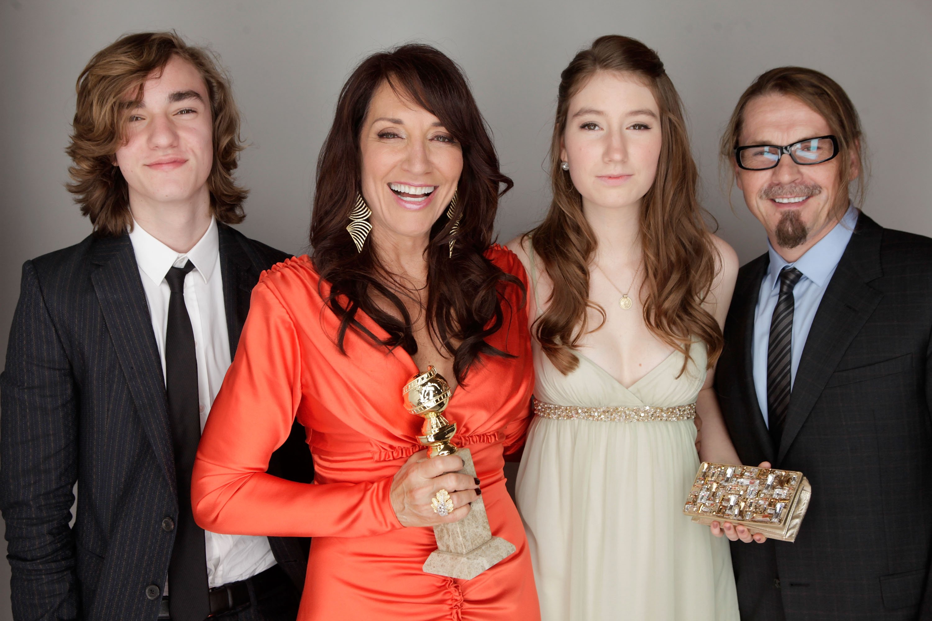 Katey Sagal, winner of the Best Performance In A Television Series - Drama for "Sons of Anarchy" poses for a portrait backstage with son James White, daughter Sarah Grace White and husband writer/director Kurt Sutter at the 68th Annual Golden Globe Awards held at The Beverly Hilton hotel on January 16, 2011 in Beverly Hills, California | Photo: Getty Images