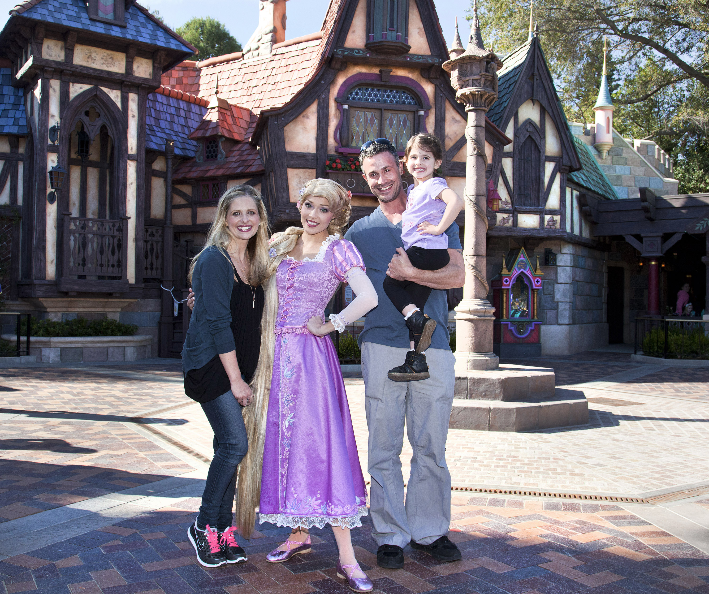 The actor with his wife and eldest daughter at the "Fantasy Faire" attraction at Disneyland on March 6, 2013 in Anaheim, California. | Source: Getty Images