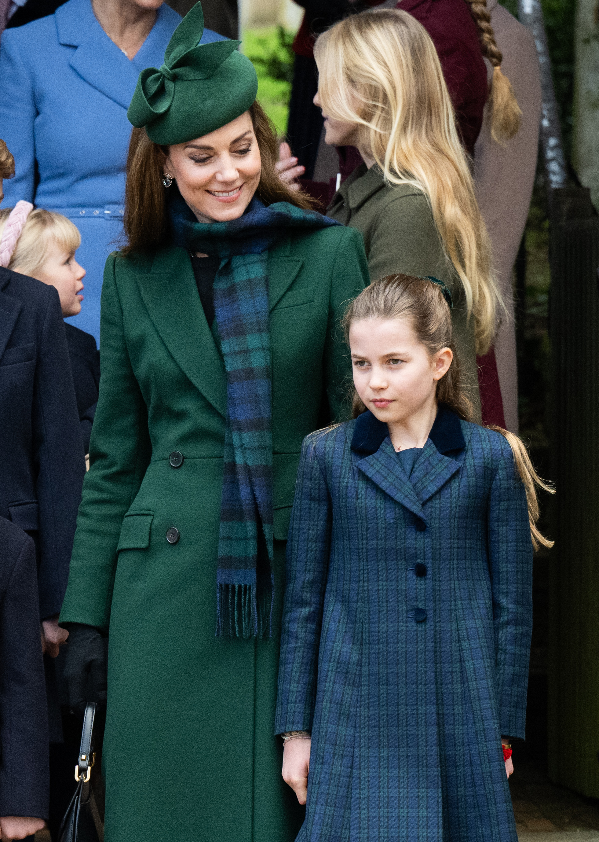 Catherine gazes warmly down at Charlotte during the Christmas Morning Service at Sandringham in December 2024 — the pair coordinated in complementary shades of green and blue tartan.