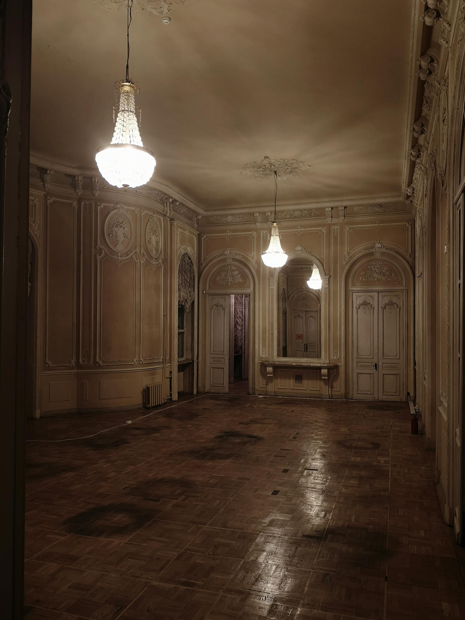 Chandeliers lit up in an abandoned building | Source: Pexels