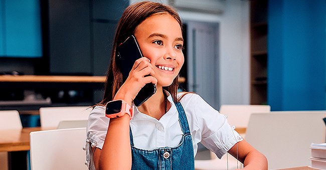 A girl happily talking on the phone. | Photo: Shutterstock