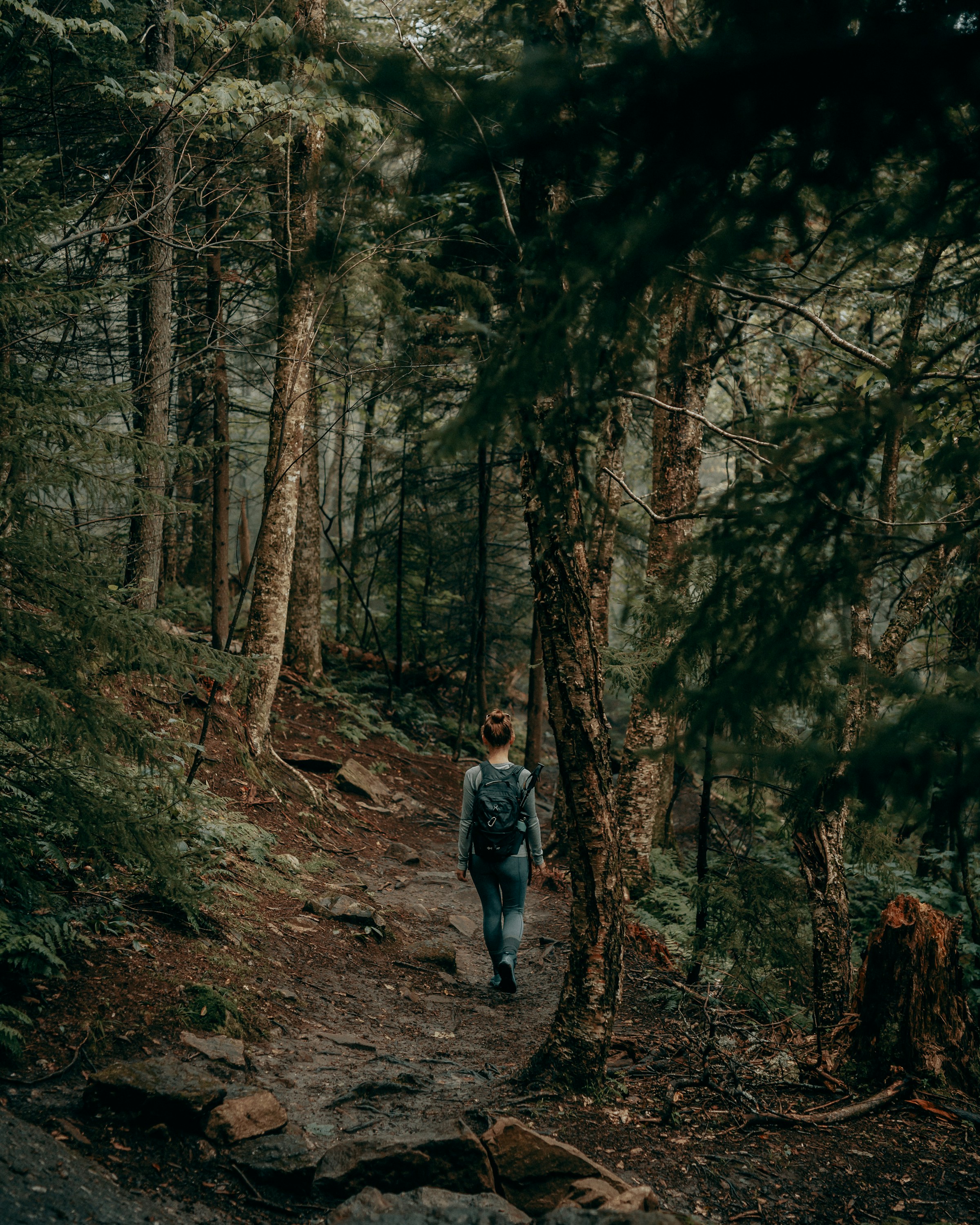 A woman walking down a hiking trail | Source: Unsplash