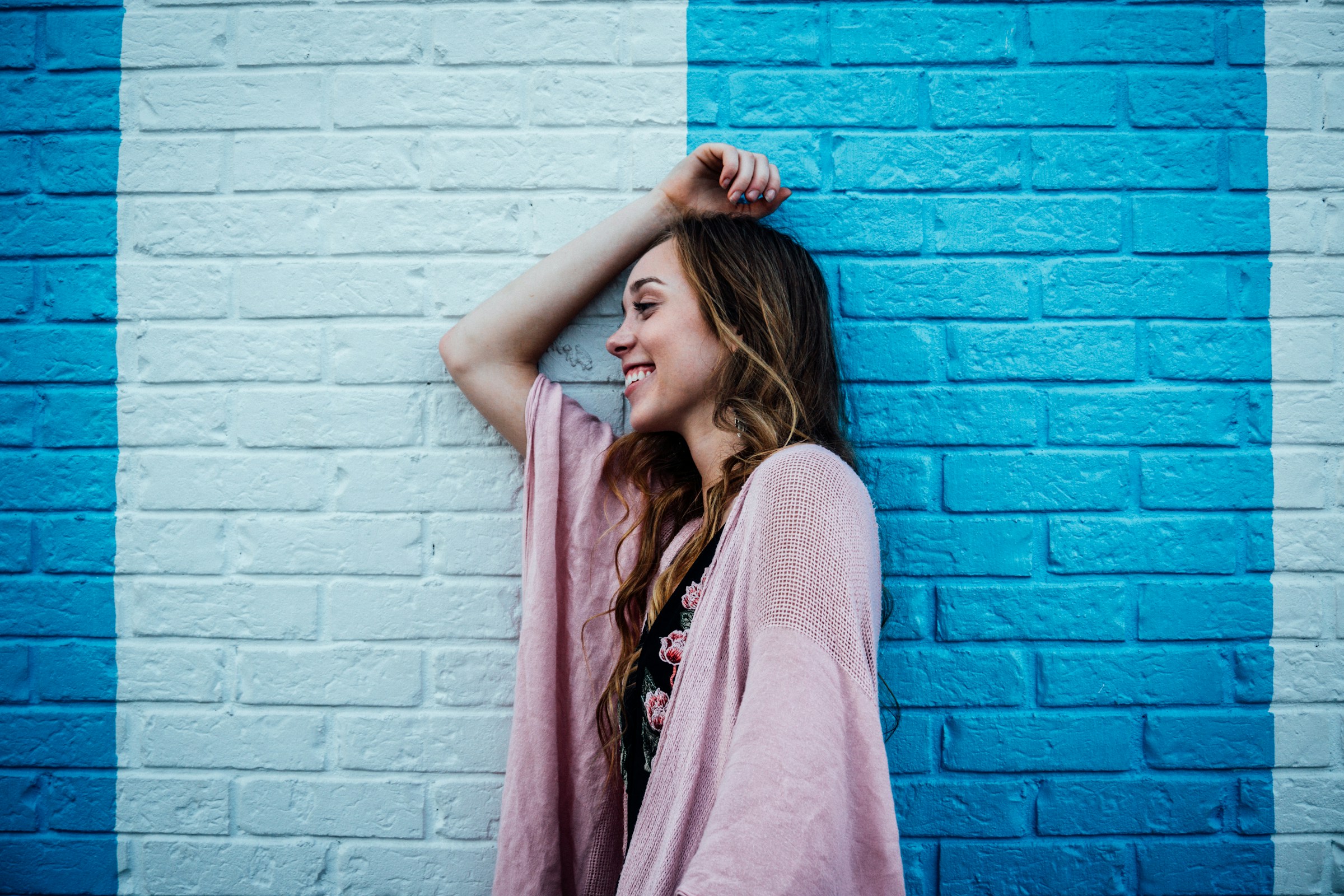 A woman leaning against a wall | Source: Unsplash