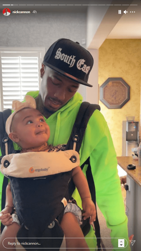 Nick Cannon is seen with his daughter Powerful Queen strapped to her chest.  Photo: Instagram/@nickcannon