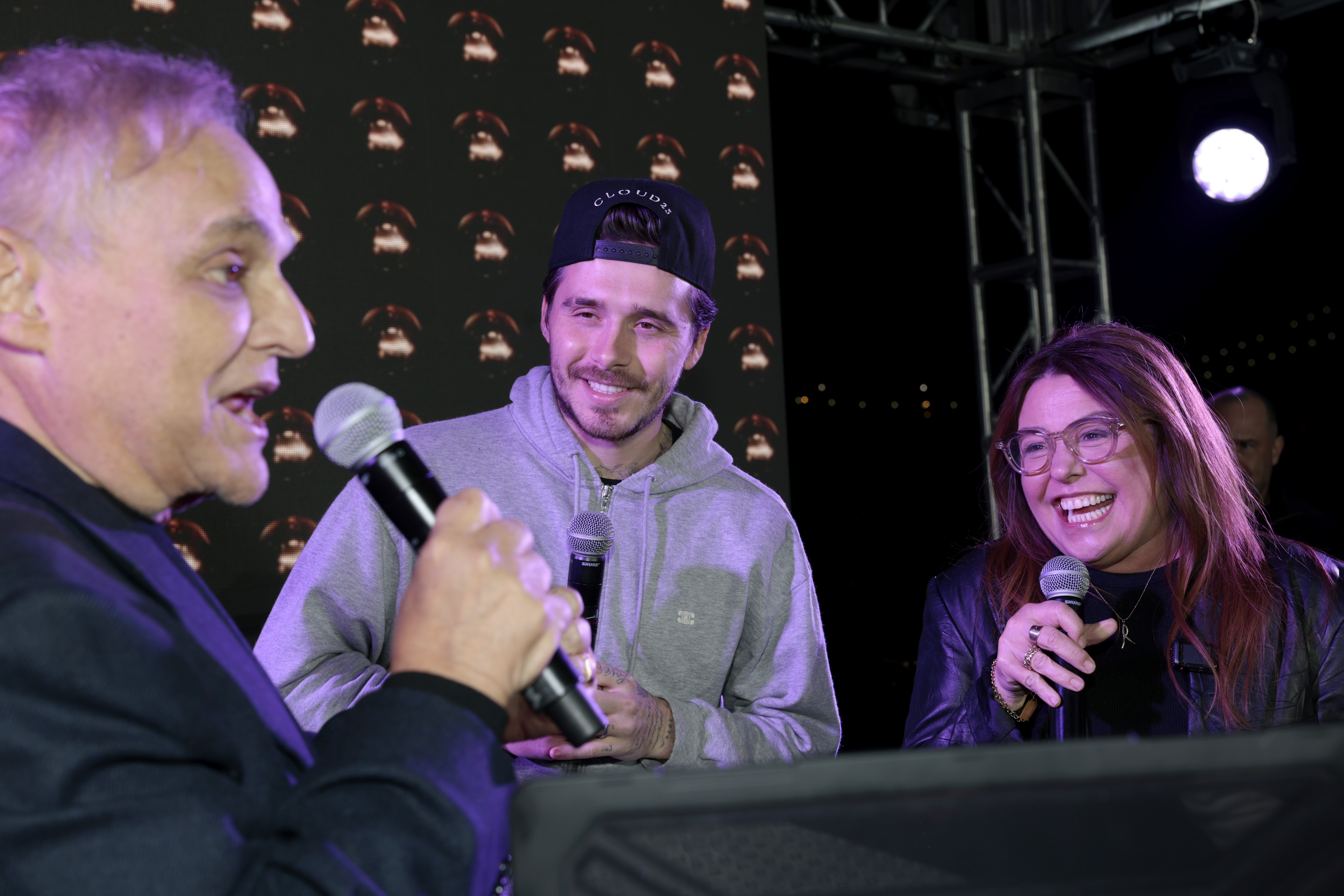 Lee Brian Schrager, Brooklyn Beckham, and Rachael Ray appear on stage at the Blue Moon Burger Bash 2.0 on October 17, 2025 | Source: Getty Images