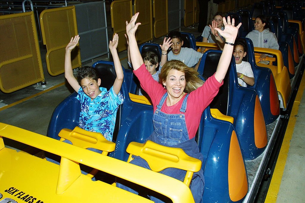 Lisa Whelchel and her son get ready to ride Goliath, a roller coaster, at Six Flags Magic Mountain | Getty Images