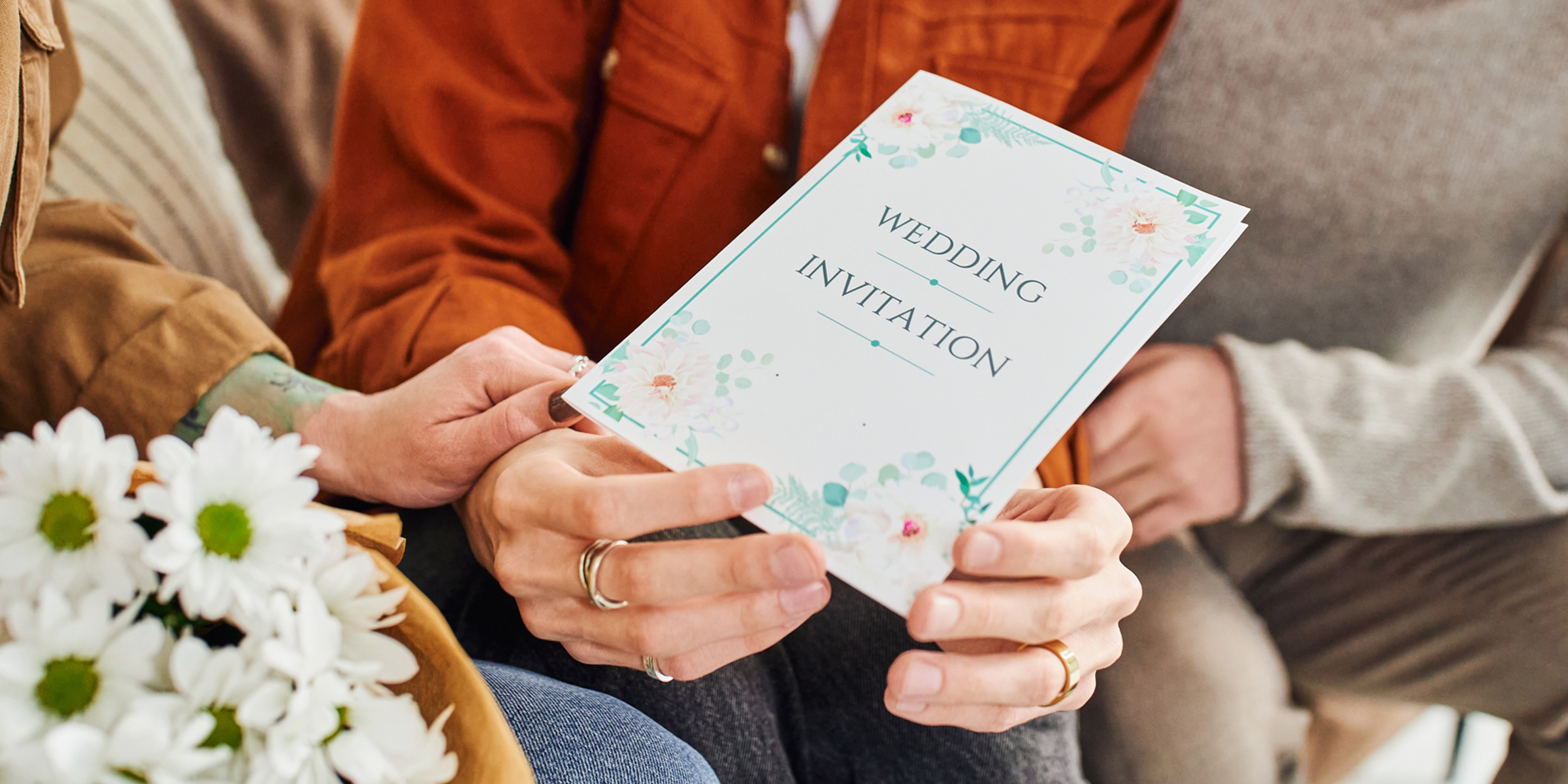 Hands holding a wedding invitation | Source: Shutterstock