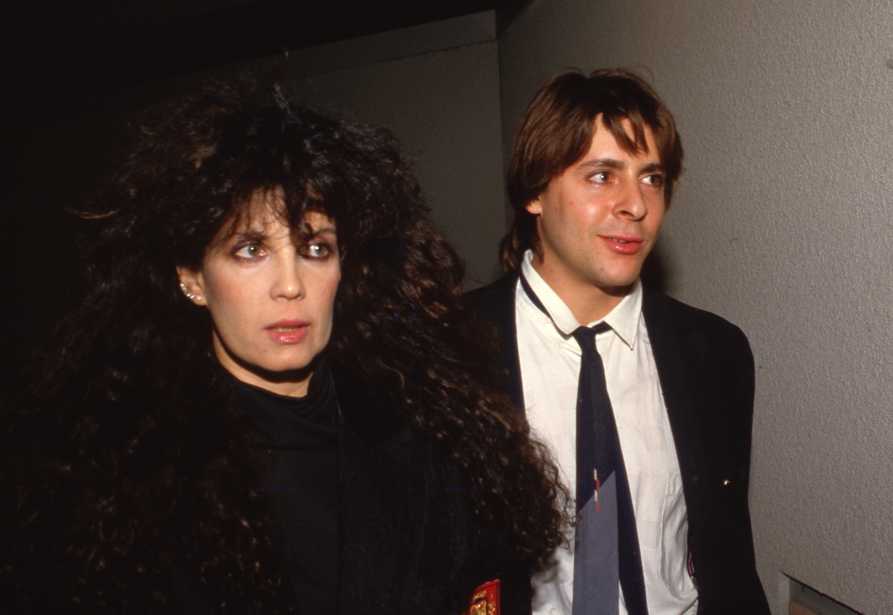 Stepping out in a sharp suit alongside jewelry designer Loree Rodkin on March 26, 1987, catching the flashbulbs at an event during the height of his mid-eighties stardom. | Source: Getty Images
