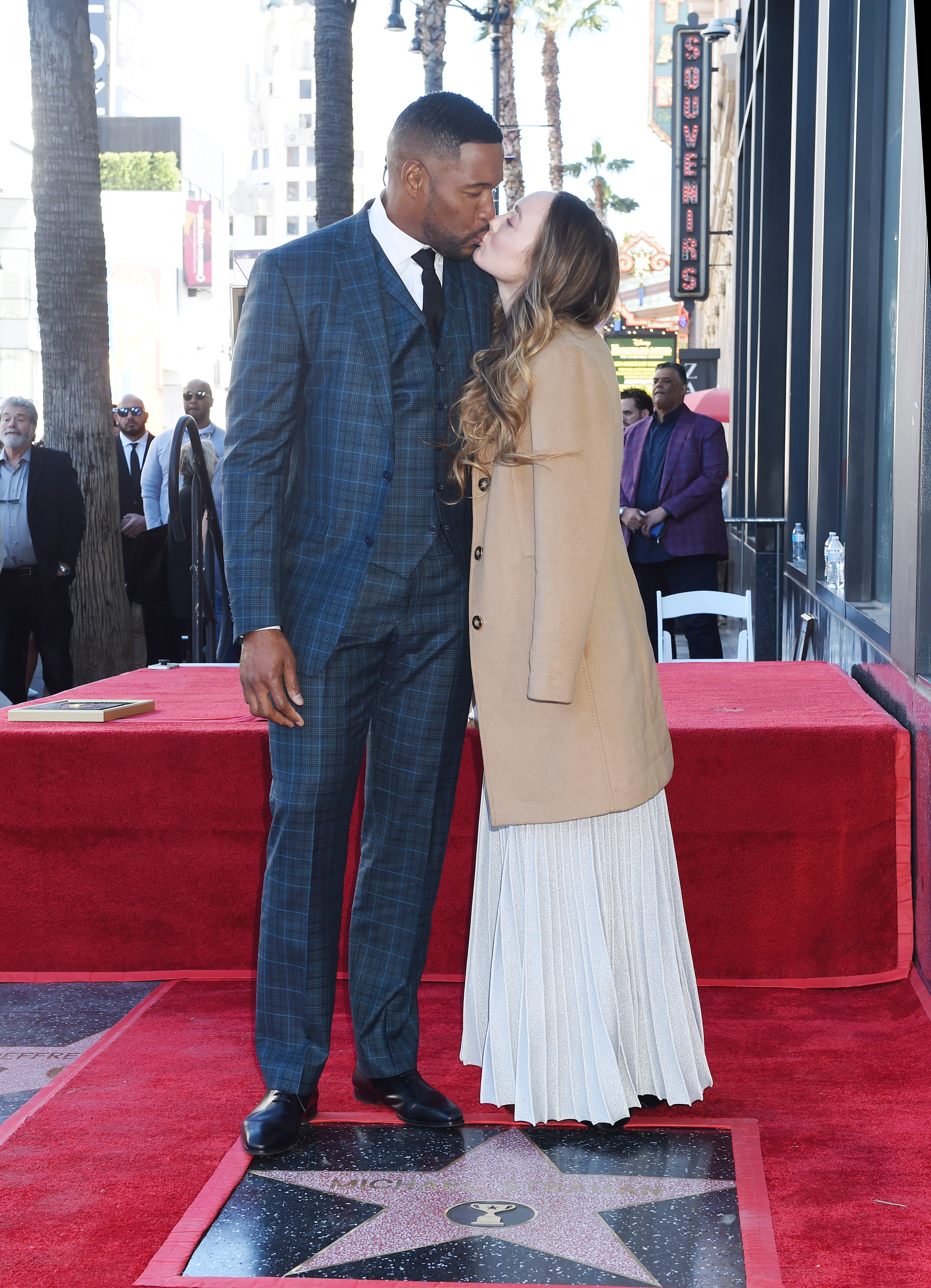 Michael Strahan kisses Kayla Quick during his first Sports Entertainment star ceremony on the Hollywood Walk of Fame in Los Angeles on January 23, 2023. | Source: Getty Images