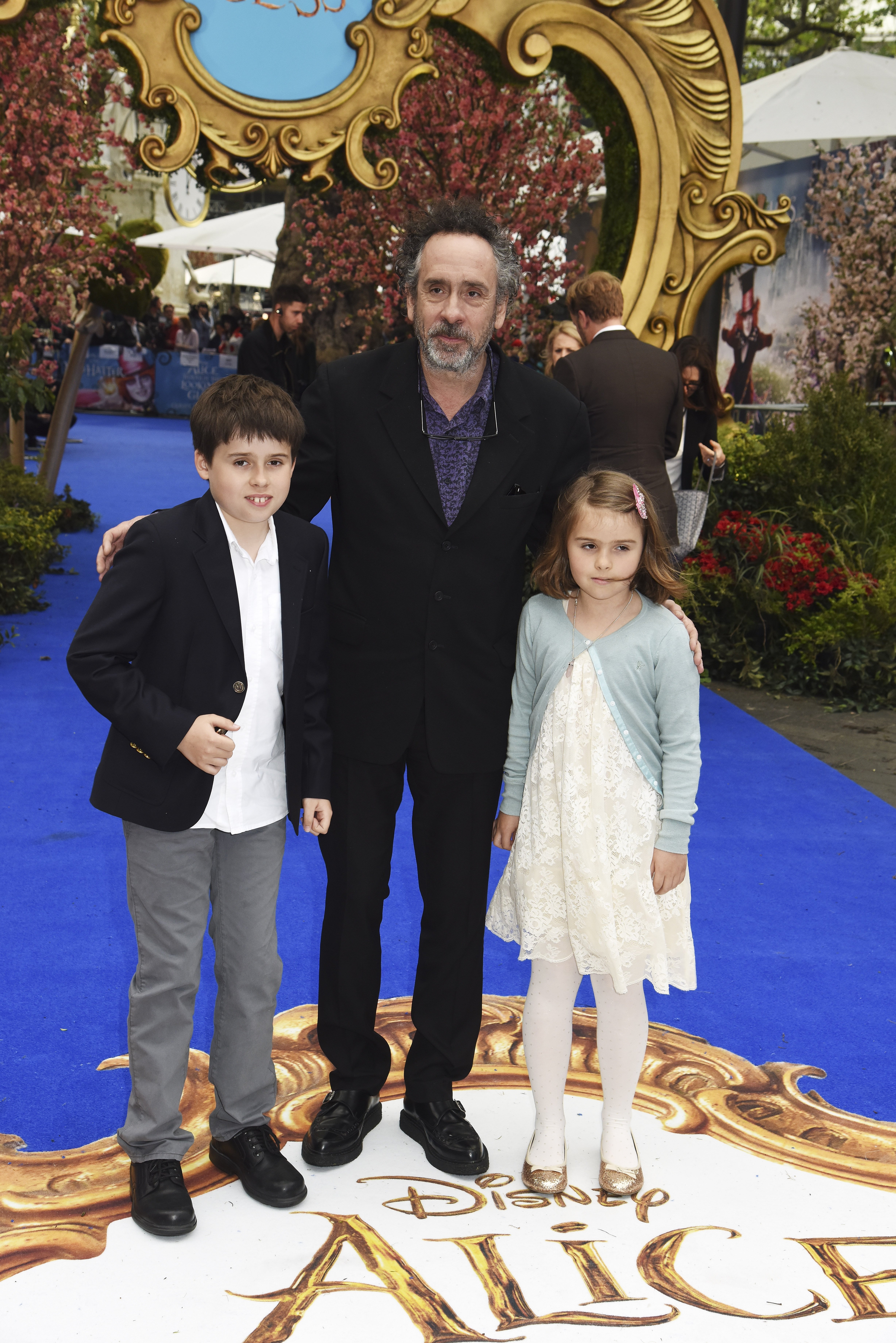 Tim Burton, Billy Burton and Nell Burton during the European Premiere of "Alice Through The Looking Glass" at Odeon Leicester Square on May 10, 2016, in London, England. | Source: Getty Images